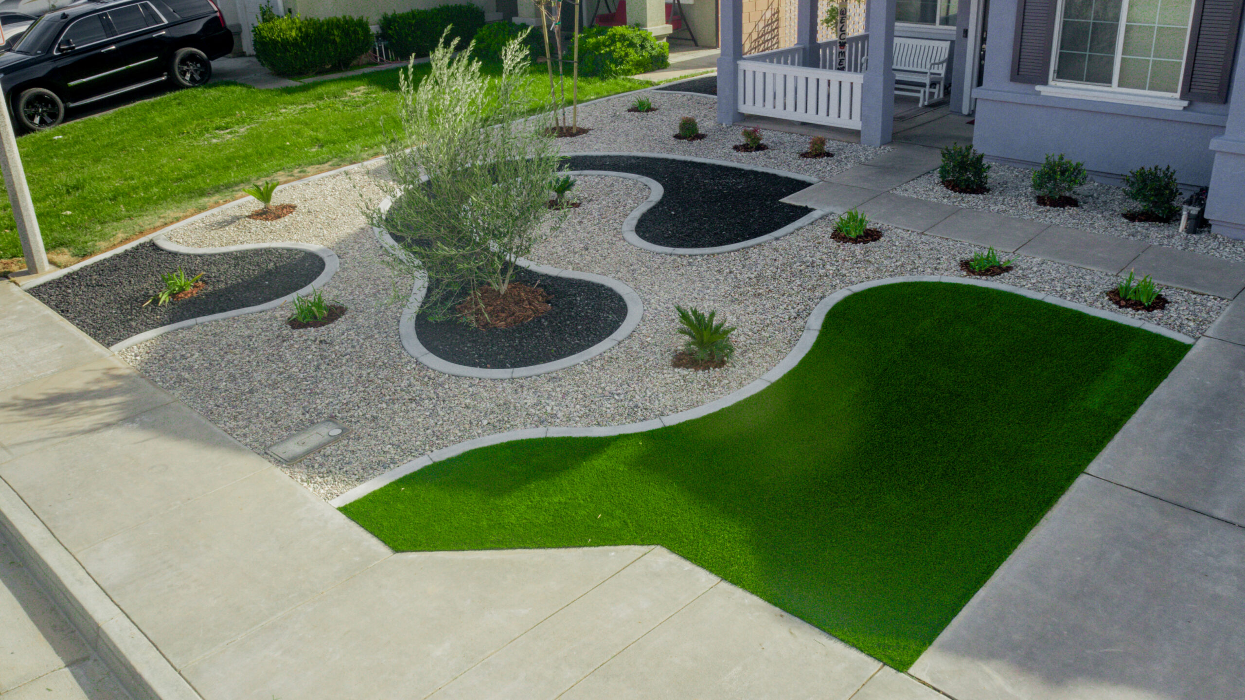 Photo of a landscaped backyard showing concrete work.